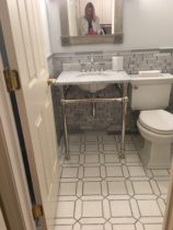 Bathroom floor is AKDO's Thassos hones with Medium Gray polished. Bathroom wall is Sukoshi in Ash Gray.