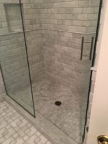 AKDO Tile used in Bathroom. Shower Walls are 3x6 AShlar beveled Carrara Marble. Shower Floor is 2x2 hexagon shaped Carrara Marble. Bathroom floor is Jazz in Carraras.