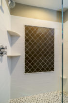 Bathroom features Shower wall field tile featured is a larger subway style Italian ceramic. Shower inset is a glass tile Moroccan pattern.