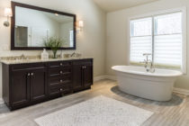 Bathroom features Italian Porcelain Tile with a natural stone mosaic tile rug. Countertops are Snow Fall granite. Blinds are Tiered Literise Vignette(color: Vin Blanc) by Hunter Douglas.