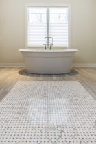 Bathroom features Italian Porcelain Tile with a natural stone mosaic tile rug.