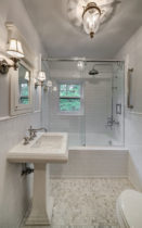 Guest Bathroom Featuring White Subway Tile and a Hexagon Mosaic Floor